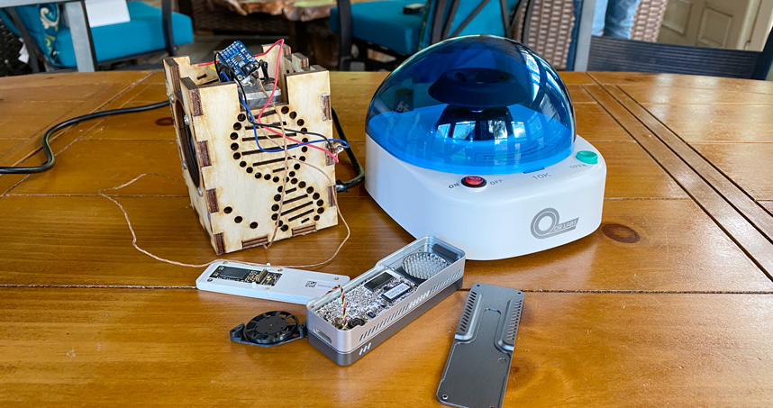 The custom-made PCR machine (left), the centrifuge (right), and the genetic sequencer (center) form GenomeLock.