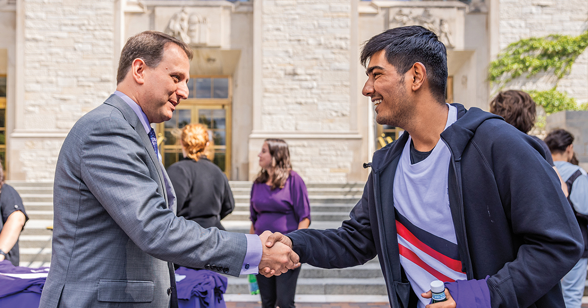 Dean Christopher Schuh greeting students