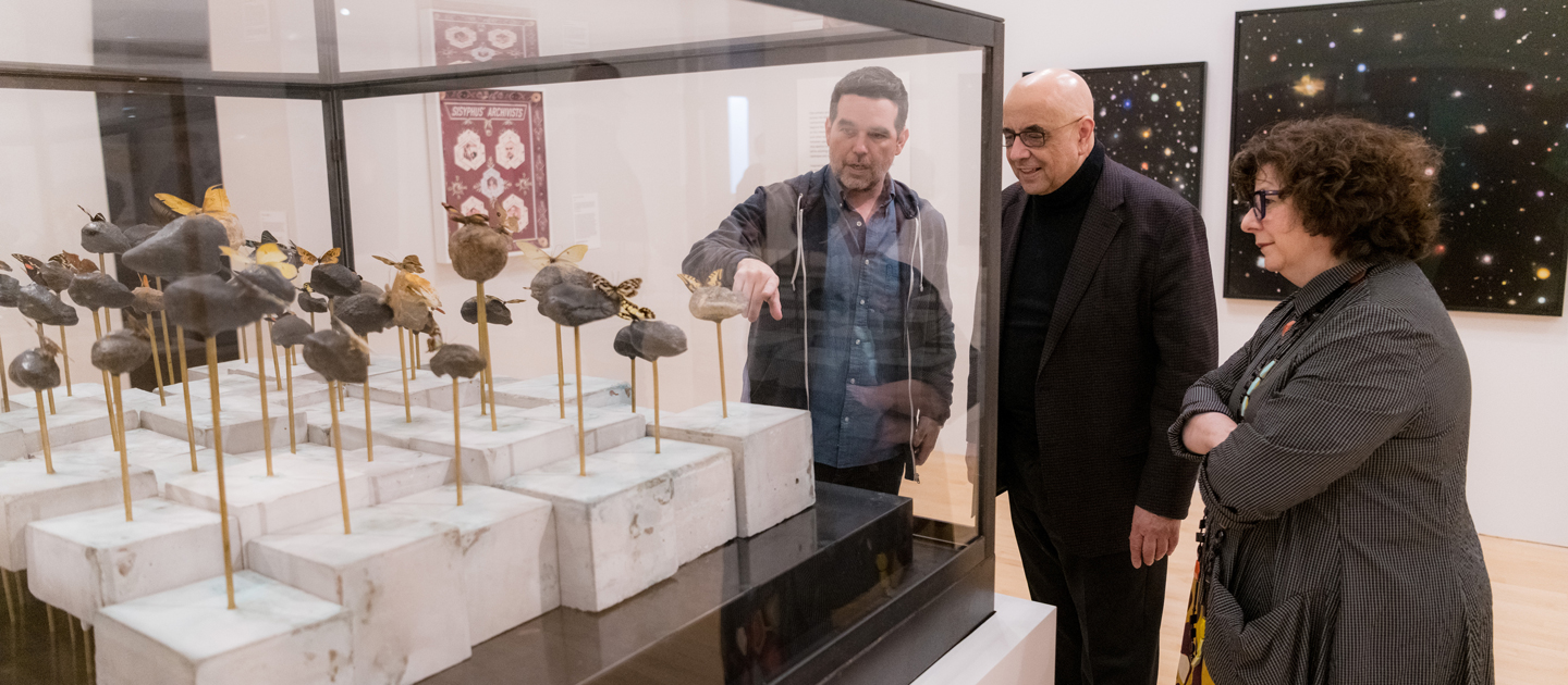 Dario Robleto, Lisa Corrin, and Dean Julio Ottino viewing The Heart's Knowledge